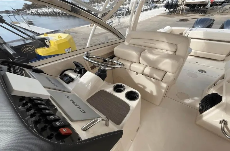 Slide: The Image of 2022 Grady-White Freedom 307 boat interior with helm, seating, and controls. - 53