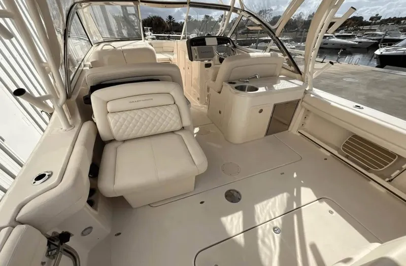 Slide: The Image of 2022 Grady-White Freedom 307 boat interior with luxurious seating and helm station. - 54