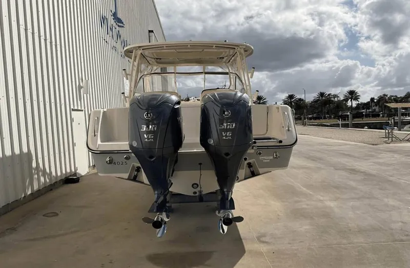 Slide: The Image of 2022 Grady-White Freedom 307 boat with dual outboard engines, docked outdoors. - 56