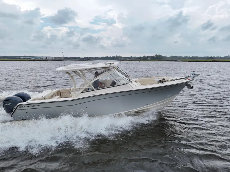 Slide: The Image of 2022 Grady-White Freedom 307 boat cruising on a scenic waterway. - 6