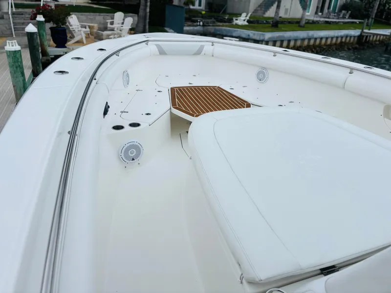 Slide: The Image of 2016 Boston Whaler 370 Outrage boat deck with seating and wood accents. - 16