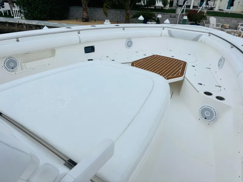 Slide: The Image of 2016 Boston Whaler 370 Outrage boat deck with white seating and wood accents. - 17