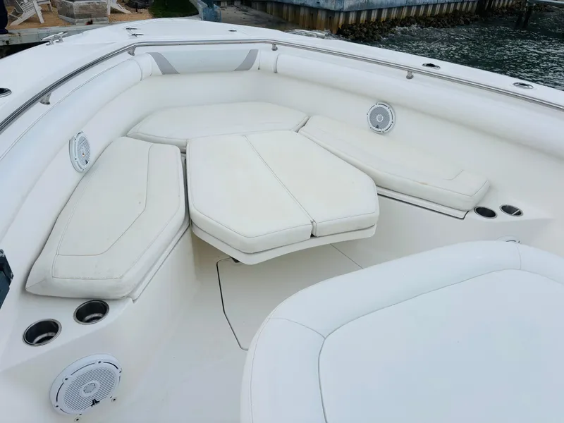 Slide: The Image of 2016 Boston Whaler 370 Outrage boat with spacious white seating area. - 18