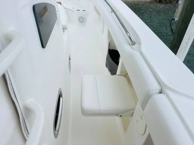 Slide: The Image of 2016 Boston Whaler 370 Outrage boat interior with white seating and sleek design. - 25