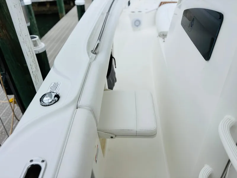 Slide: The Image of 2016 Boston Whaler 370 Outrage boat interior with white seating and sleek design. - 26