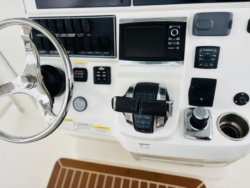Slide: The Image of 2016 Boston Whaler 370 Outrage helm with steering wheel and control panel. - 31