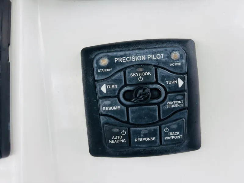 Slide: The Image of Control panel of a 2016 Boston Whaler 370 Outrage boat, featuring Precision Pilot system. - 34