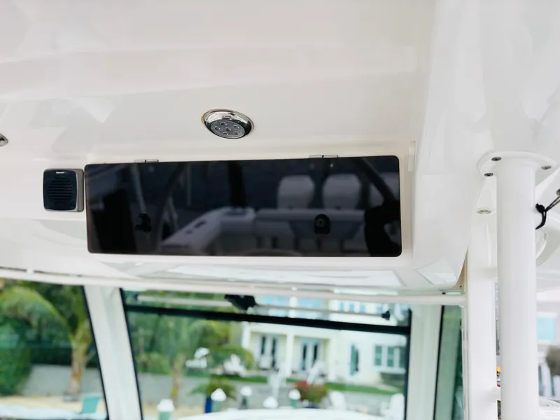 Slide: The Image of 2016 Boston Whaler 370 Outrage interior detail with overhead console and window view. - 37