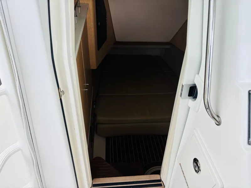 Slide: The Image of 2016 Boston Whaler 370 Outrage cabin interior with seating and storage. - 39