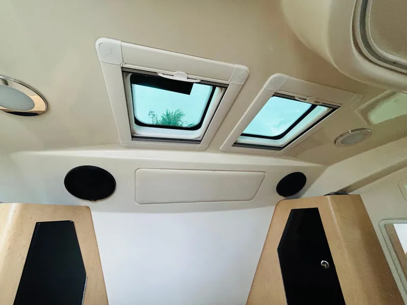 Slide: The Image of Interior view of 2016 Boston Whaler 370 Outrage cabin with skylights and speakers. - 46