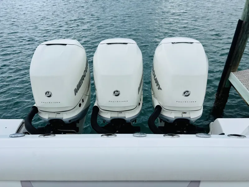 Slide: The Image of Three Mercury outboard engines on a 2016 Boston Whaler 370 Outrage boat. - 5