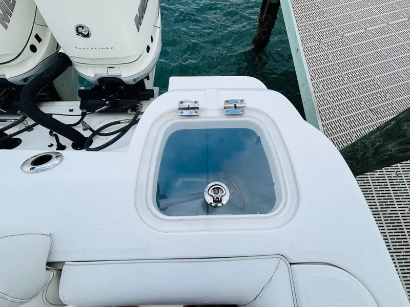 Slide: The Image of 2016 Boston Whaler 370 Outrage livewell and engine detail at dock. - 7