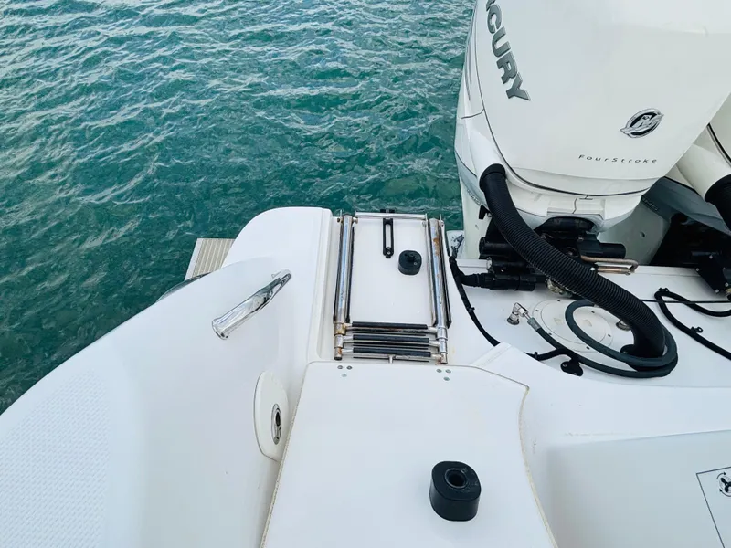 Slide: The Image of 2016 Boston Whaler 370 Outrage boat with Mercury engine, ladder, and ocean view. - 9