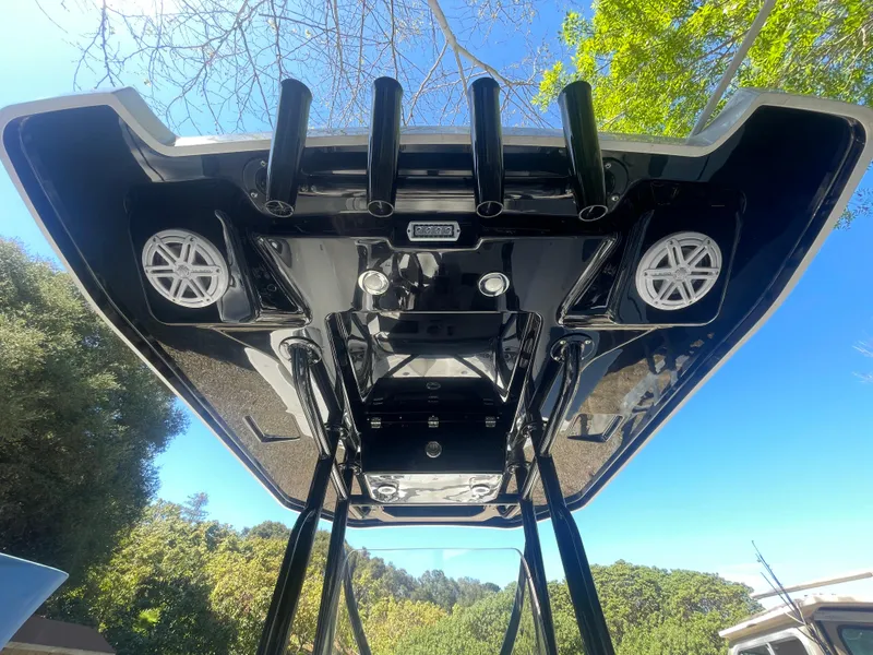Slide: The Image of 2019 Blackfin 212 CC boat canopy with speakers and rod holders, viewed from below. - 12