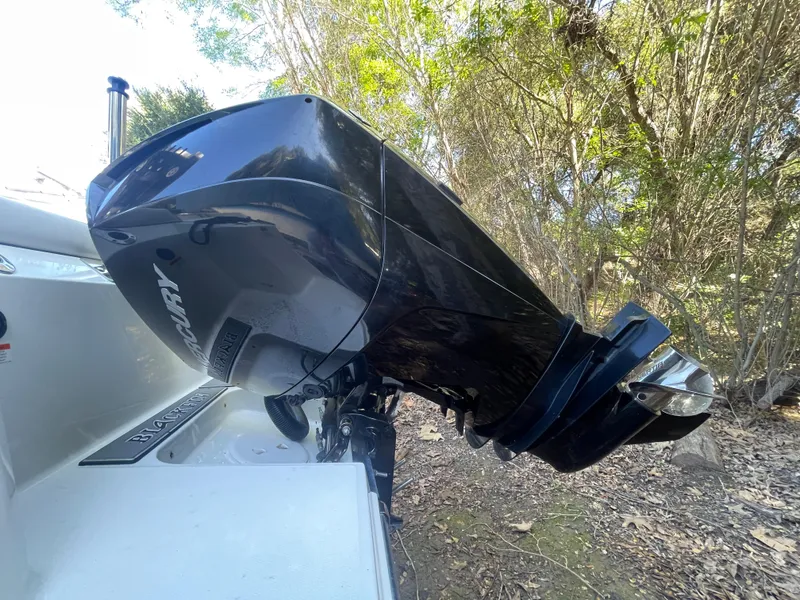Slide: The Image of 2019 Blackfin 212 CC boat with Mercury outboard motor in wooded area. - 16