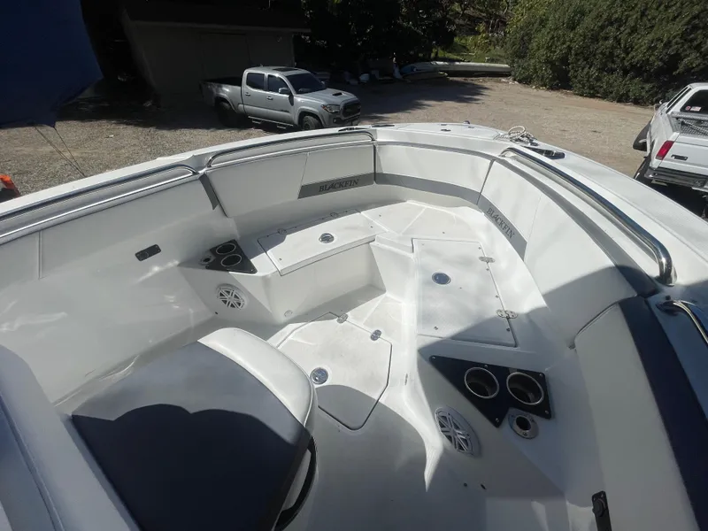 Slide: The Image of 2019 Blackfin 212 CC boat interior with seating and cup holders. - 7