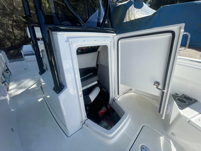 Slide: The Image of 2019 Blackfin 212 CC boat interior with open storage compartment. - 8