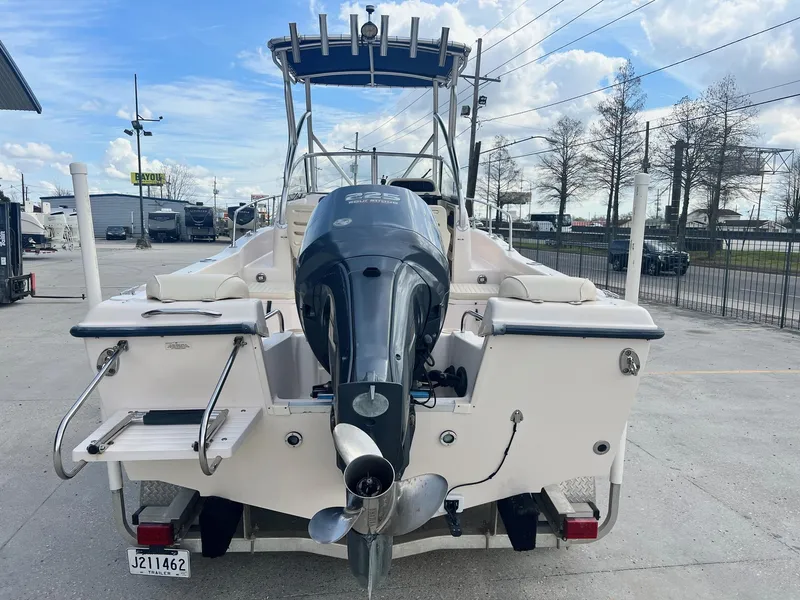 Slide: The Image of 2007 Grady-White Adventure 208 boat with outboard motor, parked outdoors. - 11