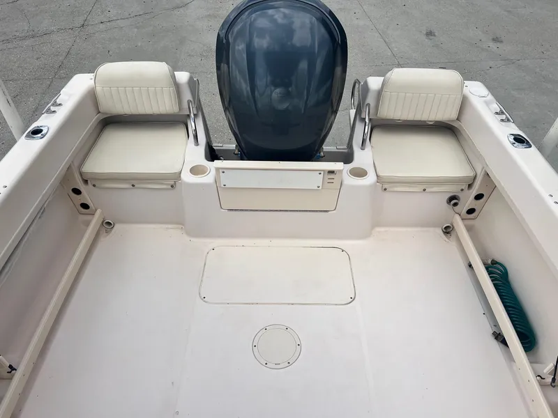 Slide: The Image of 2007 Grady-White Adventure 208 boat interior with seating and motor. - 12