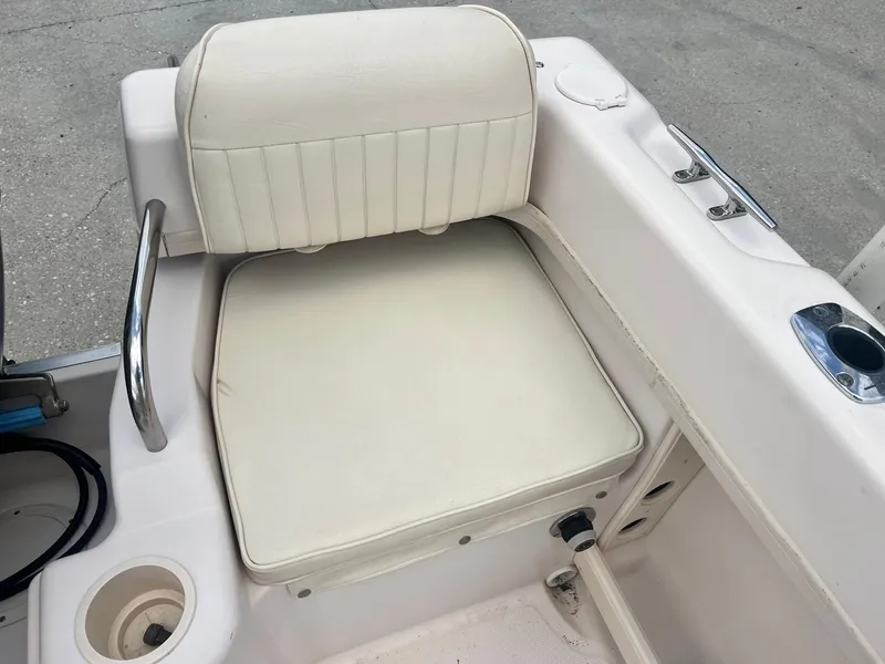 Slide: The Image of 2007 Grady-White Adventure 208 boat seat with white upholstery and cup holder. - 13