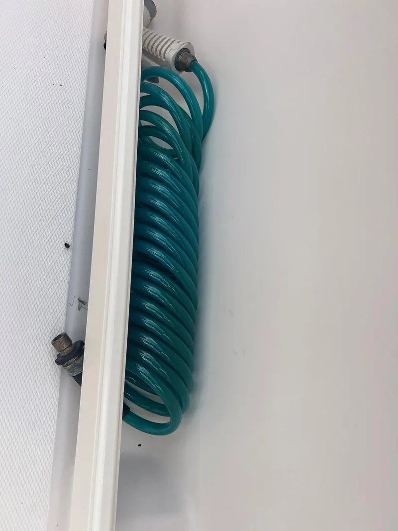 Slide: The Image of Coiled blue hose on 2007 Grady-White Adventure 208 boat deck. - 14