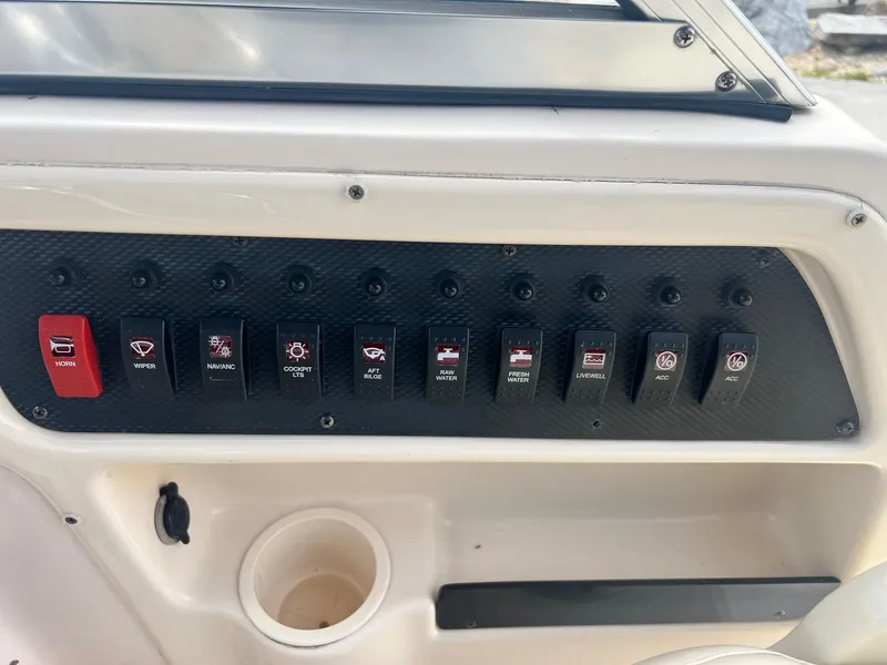 Slide: The Image of Control panel of a 2007 Grady-White Adventure 208 boat with labeled switches. - 18