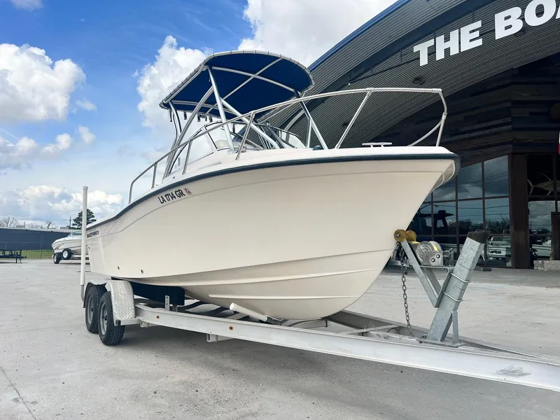 Slide: The Image of 2007 Grady-White Adventure 208 boat on trailer, parked outdoors under cloudy sky. - 3
