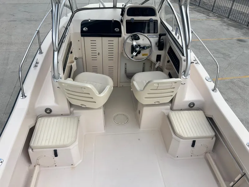 Slide: The Image of 2007 Grady-White Adventure 208 boat interior with helm, seating, and storage compartments. - 5