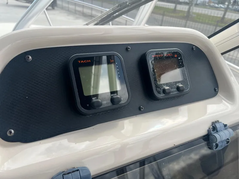 Slide: The Image of Dashboard of a 2007 Grady-White Adventure 208 boat with tachometer and speed gauges. - 8