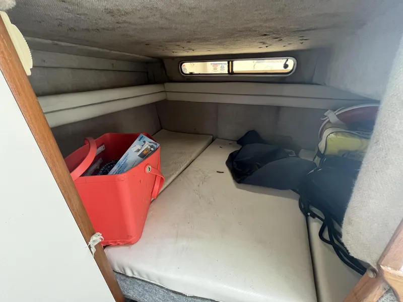 Slide: The Image of Interior cabin of 1992 Sea Ray 230 Sundancer with storage and seating area. - 10