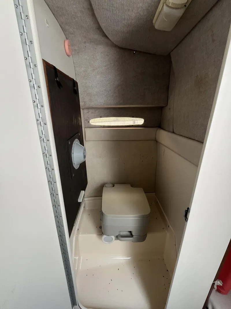 Slide: The Image of Interior of 1992 Sea Ray 230 Sundancer boat bathroom with compact toilet. - 15