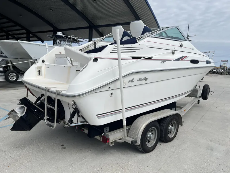 Slide: The Image of 1992 Sea Ray 230 Sundancer boat on trailer, parked in marina. - 6