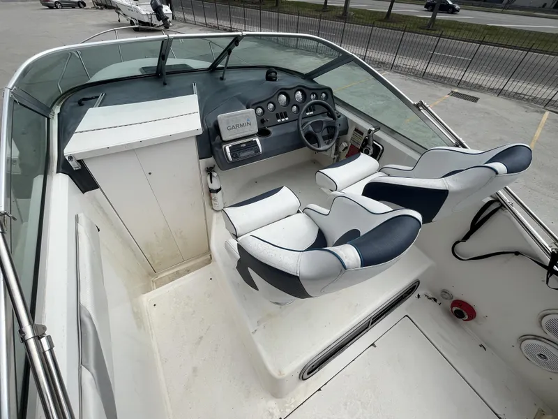 Slide: The Image of 1992 Sea Ray 230 Sundancer cockpit with dual seats and navigation equipment. - 7