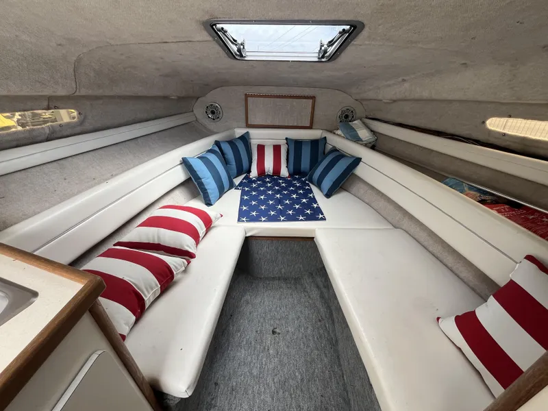 Slide: The Image of Interior of 1992 Sea Ray 230 Sundancer with patriotic-themed cushions and seating. - 9