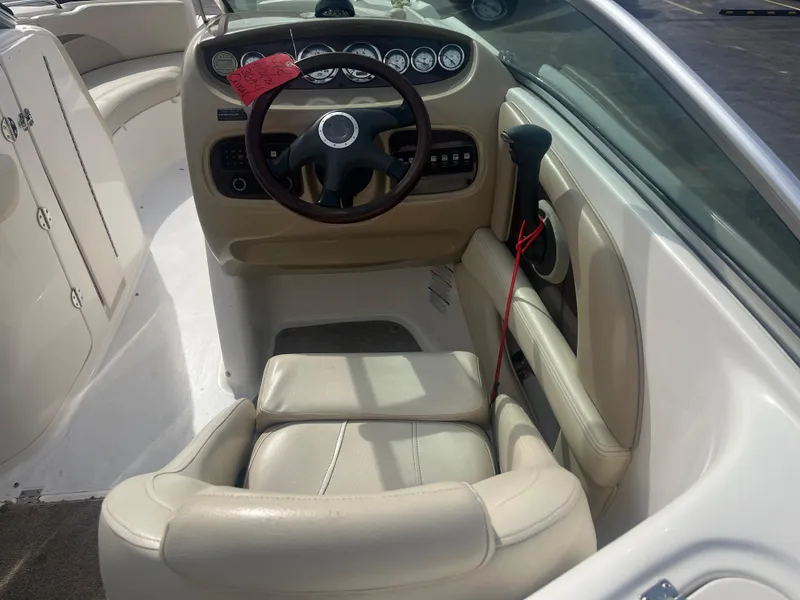 Slide: The Image of 2004 Chaparral Sunesta 254 boat cockpit with steering wheel and gauges. - 13
