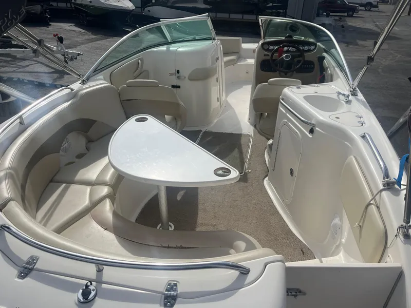 Slide: The Image of 2004 Chaparral Sunesta 254 boat interior with seating and table, showcasing luxury design. - 14