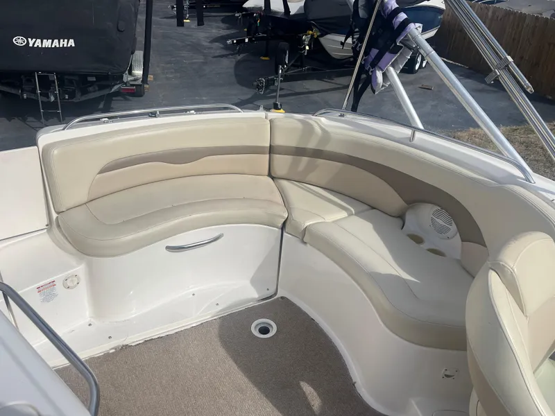 Slide: The Image of 2004 Chaparral Sunesta 254 boat interior with beige seating and carpeted floor. - 15
