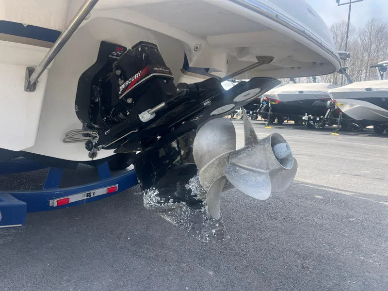 Slide: The Image of 2004 Chaparral Sunesta 254 boat with Mercury MerCruiser engine and propeller, parked on trailer. - 3