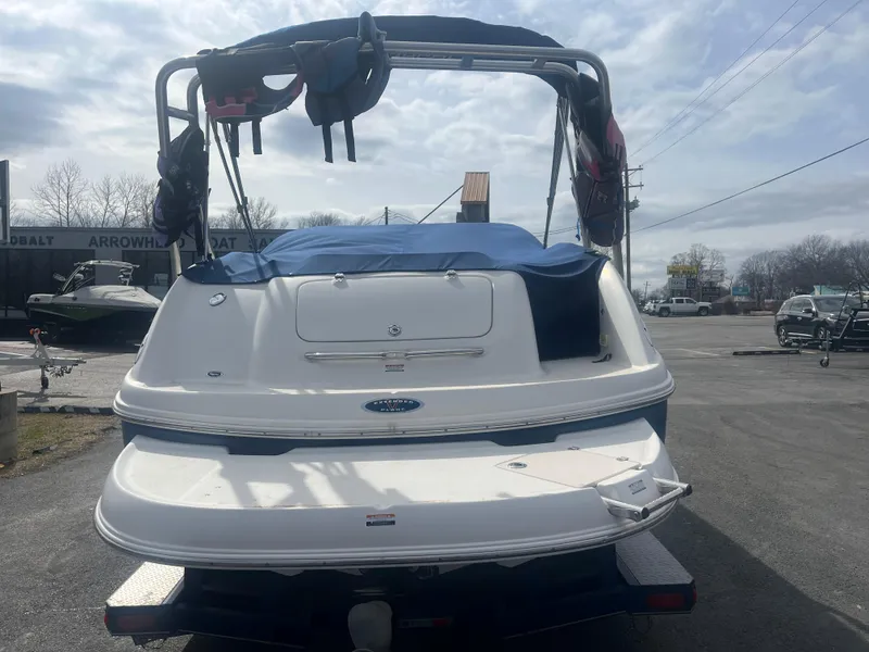 Slide: The Image of 2004 Chaparral Sunesta 254 boat, rear view, parked outdoors under cloudy sky. - 4