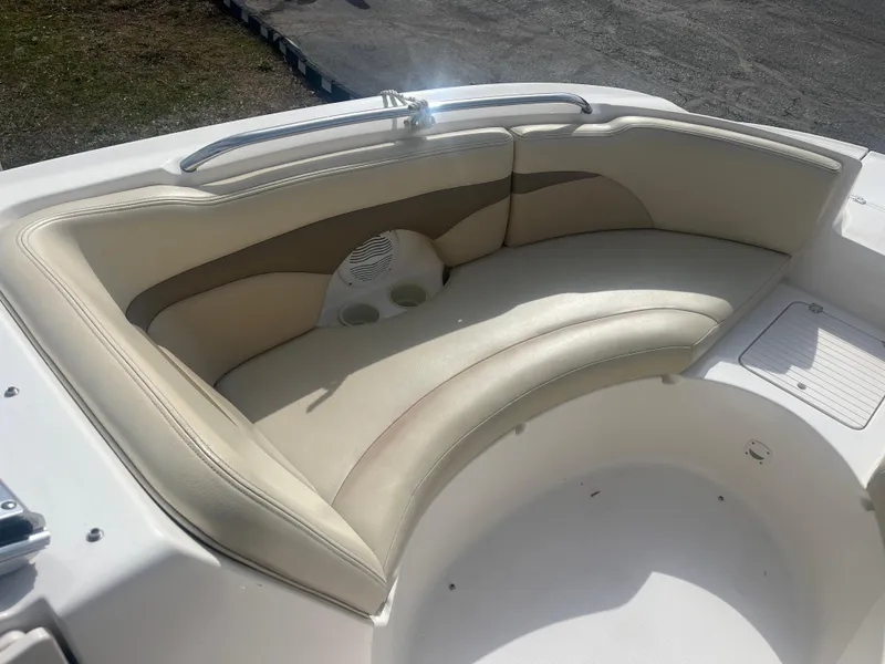 Slide: The Image of 2004 Chaparral Sunesta 254 boat interior with beige seating and cup holders. - 8