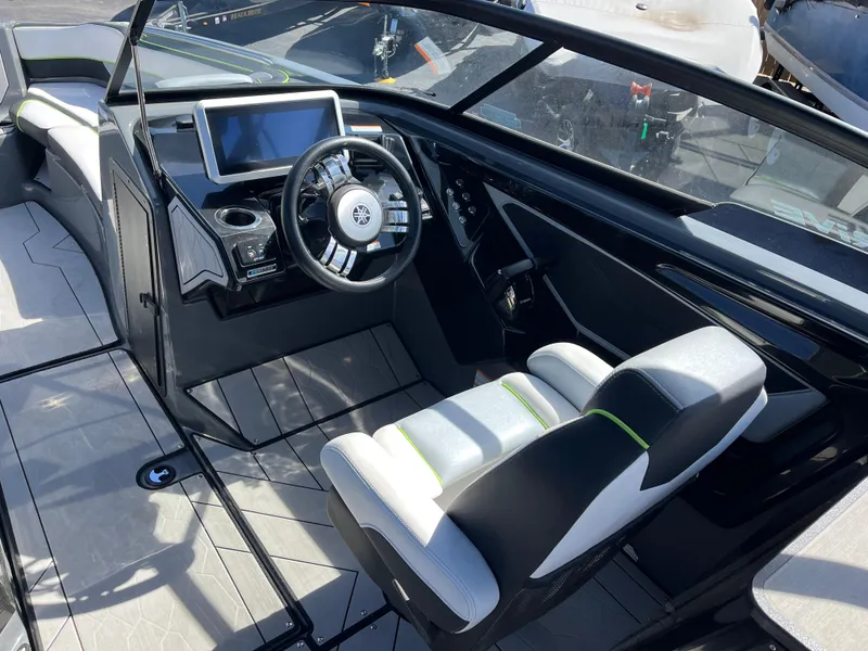 Slide: The Image of Interior of 2021 Yamaha Boats 255X, featuring sleek dashboard and modern steering wheel. - 10