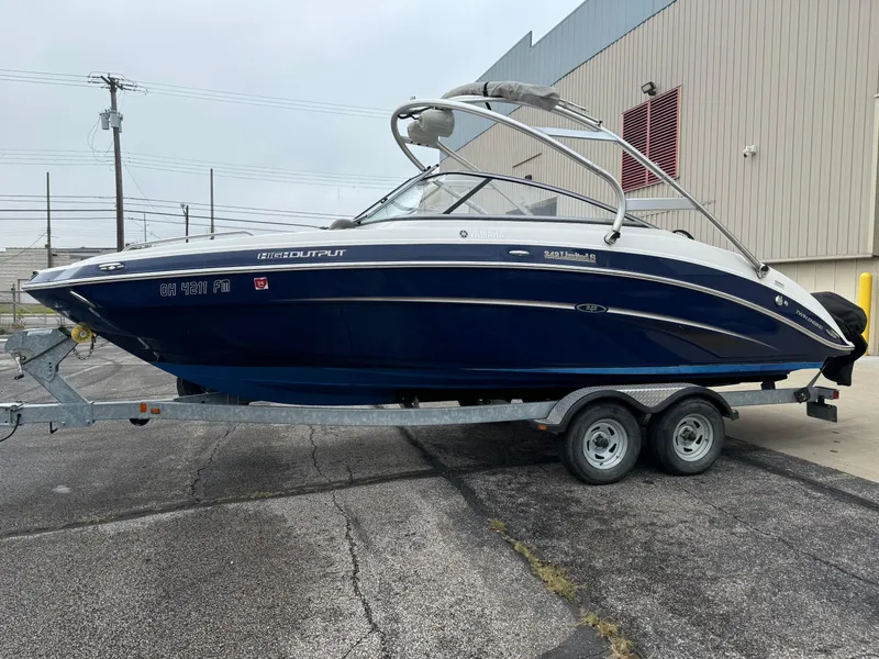 Slide: The Image of 2014 Yamaha Boats 242 Limited S on trailer, parked outdoors. - 2