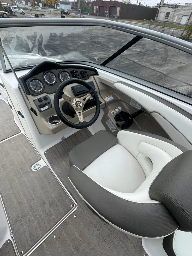 Slide: The Image of 2014 Yamaha Boats 242 Limited S cockpit with steering wheel and dashboard controls. - 4