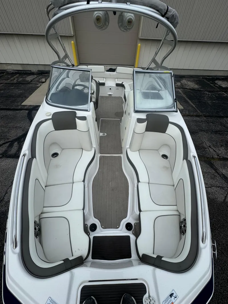 Slide: The Image of 2014 Yamaha Boats 242 Limited S interior with white seating and open windshield. - 5
