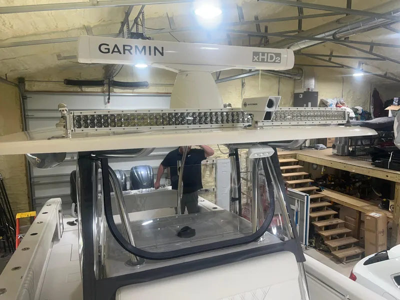 Slide: The Image of 2022 Contender 39 ST boat in garage, featuring advanced navigation system and sleek design. - 19