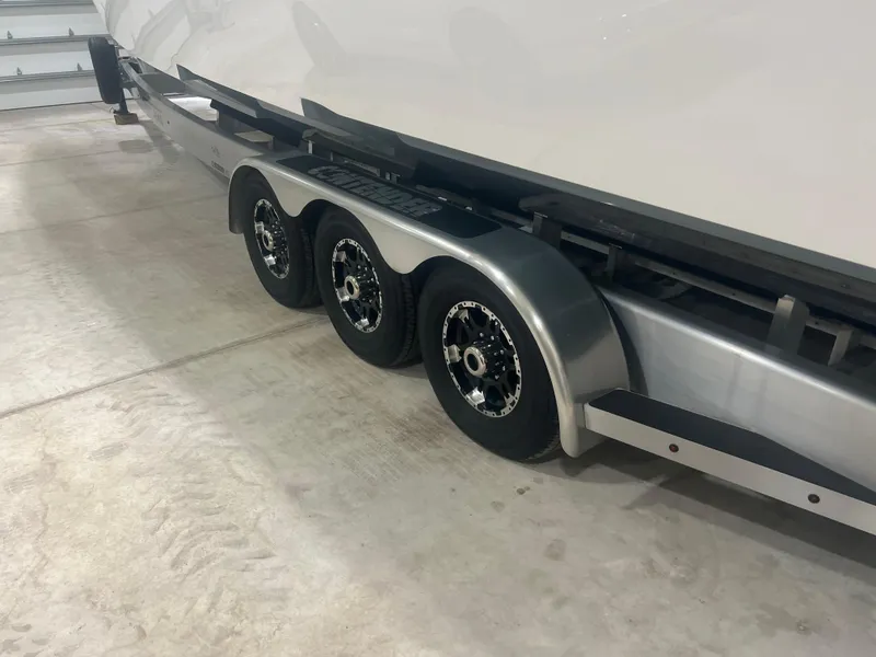 Slide: The Image of Contender 39 ST 2022 boat compartment with secure latches and sleek design. - 27