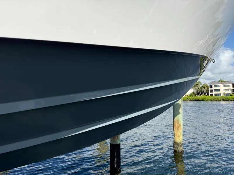 Slide: The Image of 2022 Contender 39 ST boat hull in water, showcasing sleek design and craftsmanship. - 31