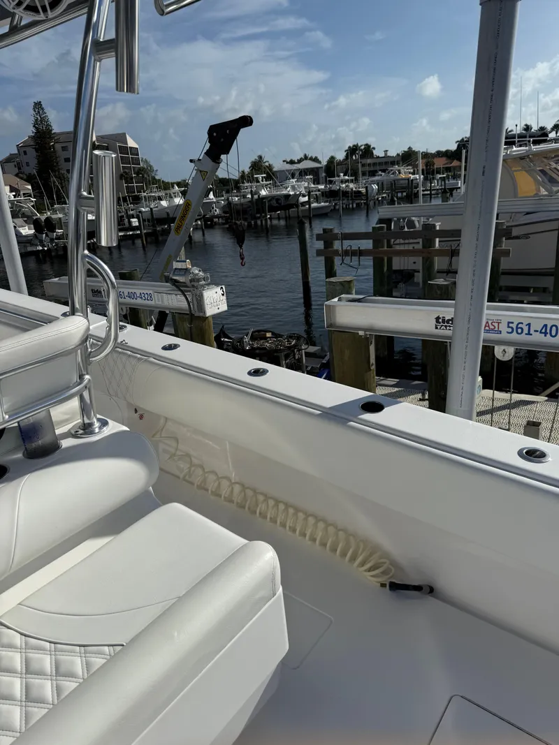 Slide: The Image of 2022 Contender 39 ST boat docked at marina under clear blue sky. - 33