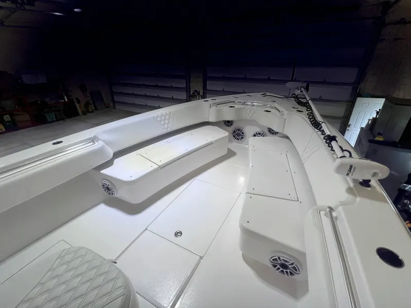 Slide: The Image of 2022 Contender 39 ST boat in a garage with a white SUV nearby. - 5