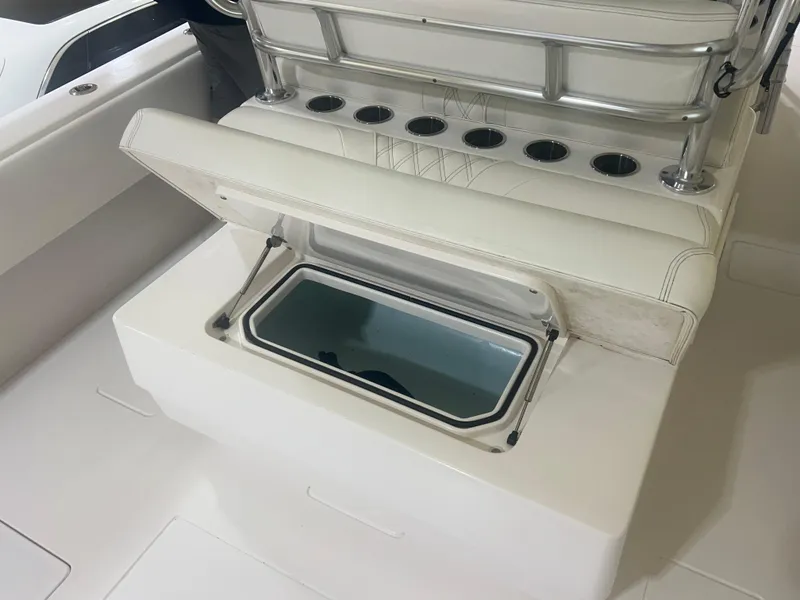 Slide: The Image of 2022 Contender 39 ST boat interior with white seating and storage compartments. - 8